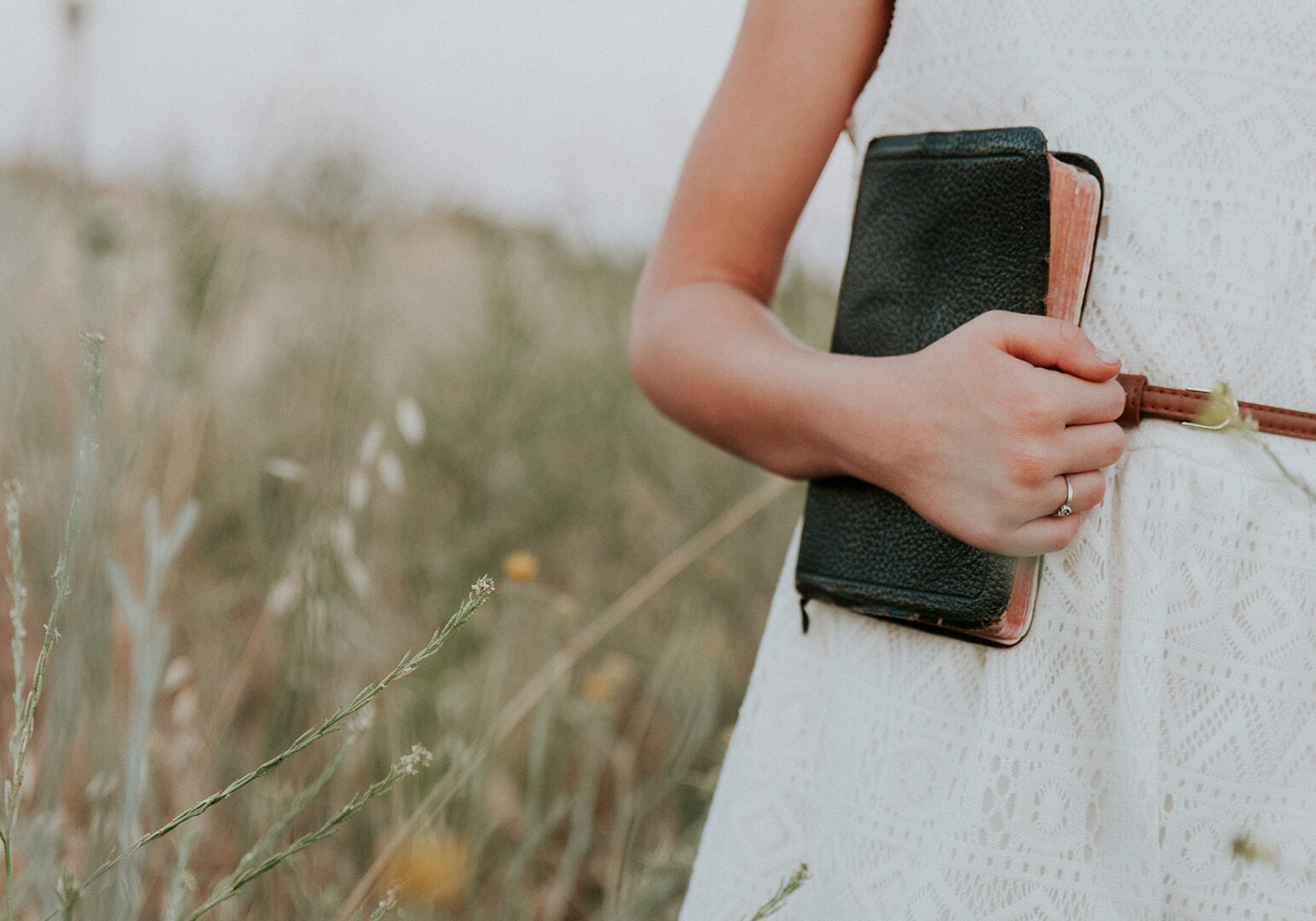 Girl-in-field-with-Bible