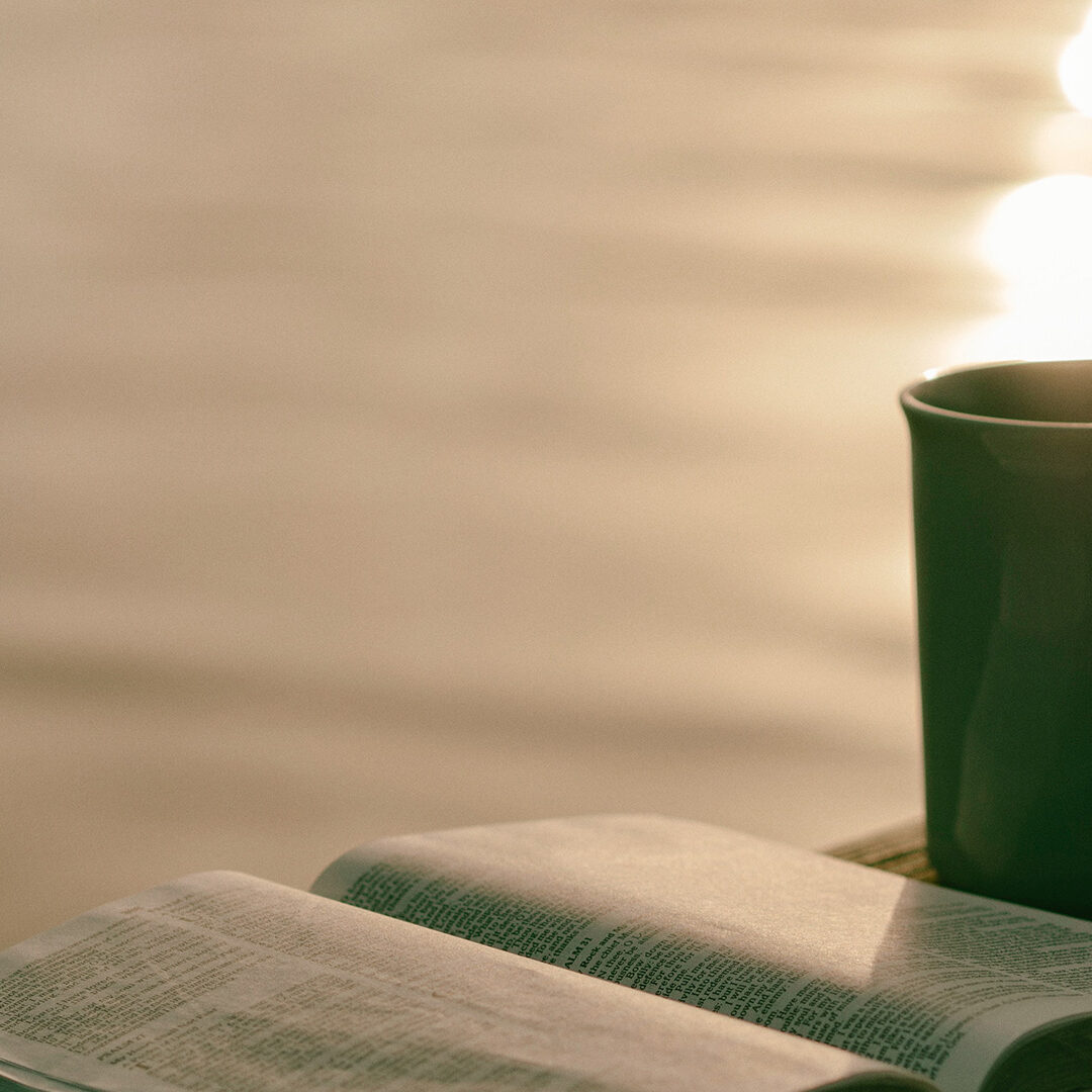 green-ceramic-mug-beside-book