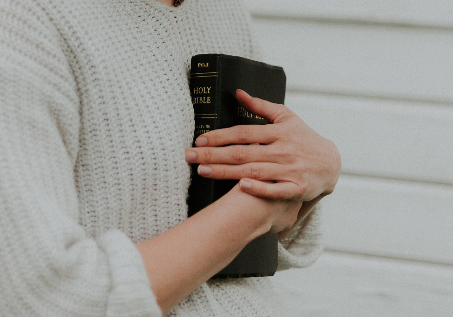 woman-holding-bible-sweater